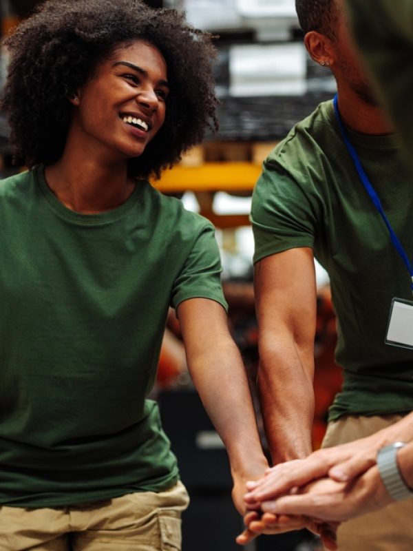 Happy,Volunteers,Joining,Hands,,Demonstrating,Teamwork,,Unity,,And,Collaboration,While